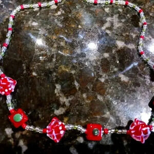 Beautiful  beaded necklace with seven different charms on it.